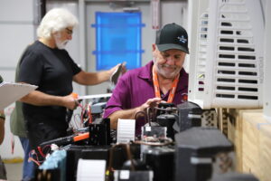 Technicians practicing hands-on troubleshooting during an RV air conditioner training class at NRVTA